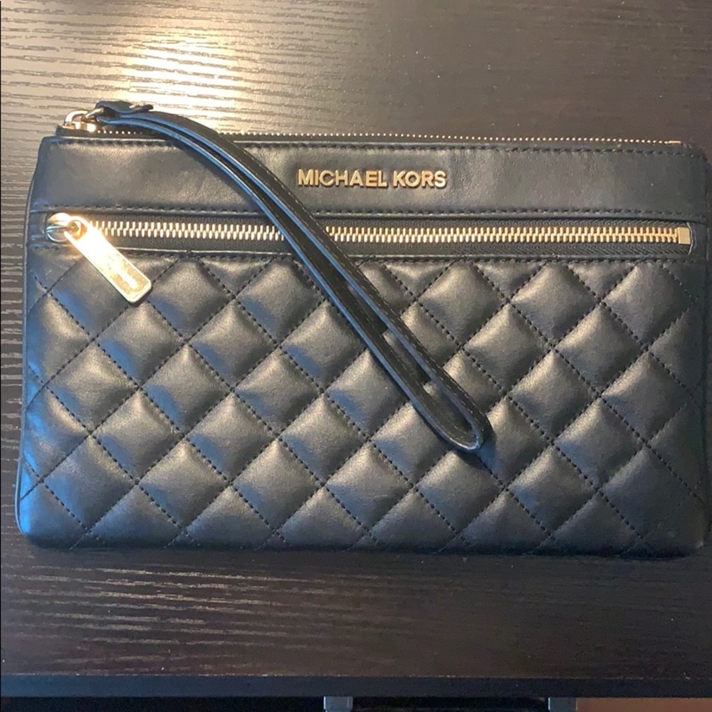 Black Michael Korda wristlet. Gold hardware.